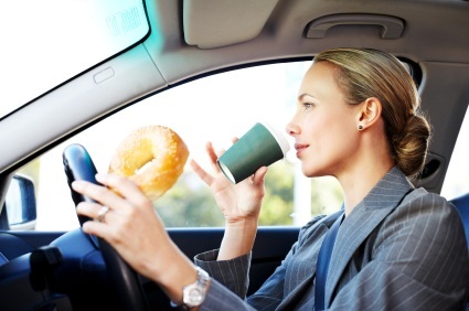 Businesswoman Driving to Work and Having Breakfast