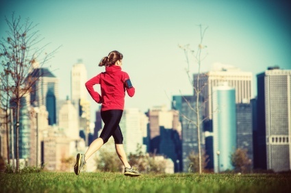 women running with smartphone in new york city