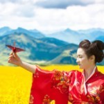 geisha in a yellow field holding a paper crane