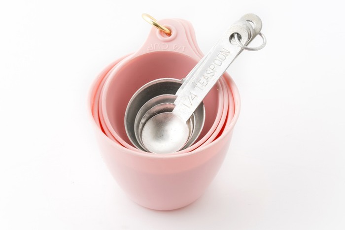 pink measuring cups and silver measuring spoons
