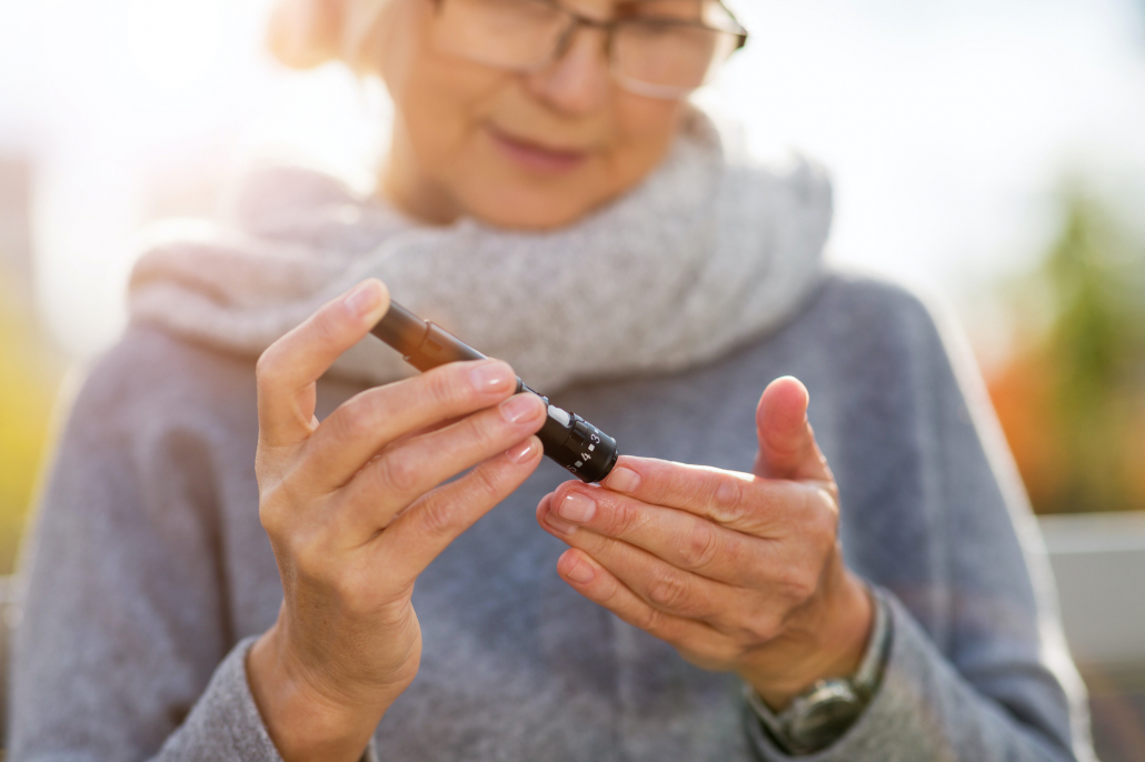 older woman with diabetes checking blood sugar levels