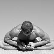 Strong Man Practicing Yoga bend over grabbing toes
