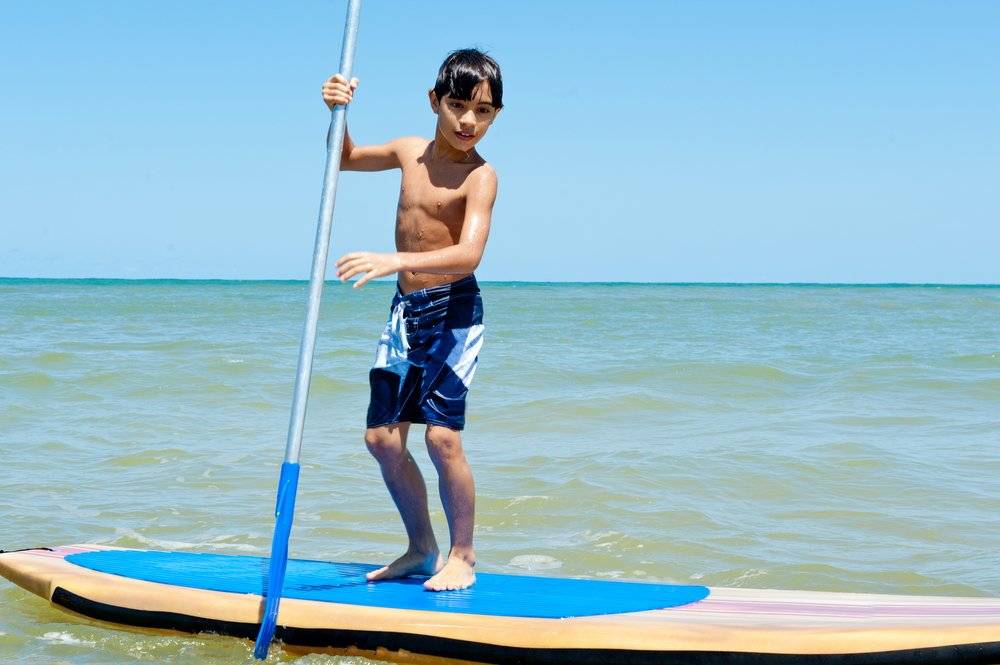 a child paddle boarding